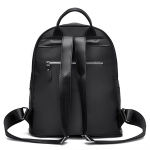 Classic black faux leather backpack with rivet accents and anti-theft back pocket zipper