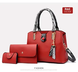 Detailed set of 3 red tote bags featuring snakeskin texture and gold hardware accents