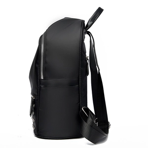 Fashionable black studded backpack with silver rivets and side zipper details
