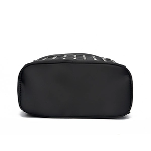 Bottom view of black rivet backpack with soft leather finish and silver stud details