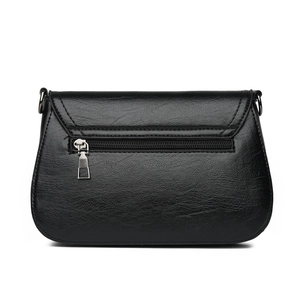 Black oil wax leather crossbody bag featuring a functional back zipper pocket and silver hardware