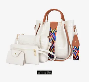 Detailed view of white crocodile pattern 4-piece handbag set with ethnic shoulder straps