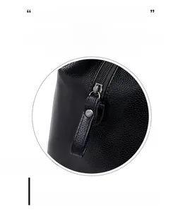 Detailed macro of smooth silver metal zipper on premium black lychee leather tote bag