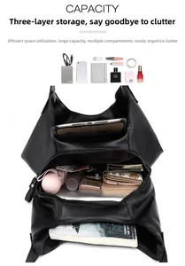 Detail of black pebbled leather tote showing triple compartments and large inner capacity