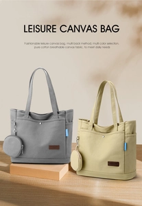 Close-up of canvas tote bags in grey and beige with matching round hanging coin purses