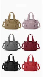Matrix showing six colors of minimalist nylon shoulder bags with top handles and straps
