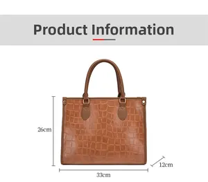 Detail view of brown crocodile embossed tote bag showing 33x26x12 cm dimensions