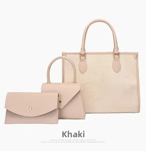 Detailed set of khaki tote bags with crocodile pattern embossing and gold hardware