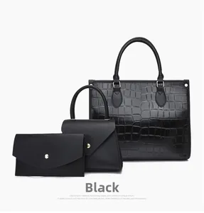 Detail of black 3-in-1 handbag set featuring crocodile embossed texture and gold hardware