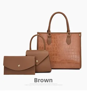 Three-piece brown embossed crocodile tote bag set with matching wallet and gold hardware