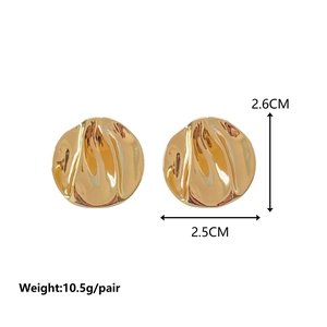 Detail of irregular hammer-textured gold earrings with 2.6cm x 2.5cm size markings