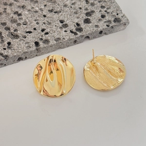 Golden irregular round hammer textured earrings with lava pattern on white background