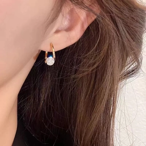 Elegant minimalist gold U-shape hoop earring featuring a brilliant round cubic zirconia drop