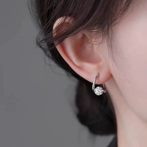 Minimalist silver hoop earrings with a sparkling round-cut gemstone solitaire