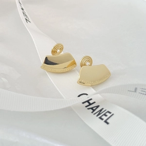 Elegant gold fan-shaped clip-on earrings with engraved text on minimalist white silk