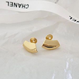 Elegant gold fan-shaped clip earrings with engraved text on a minimalist background