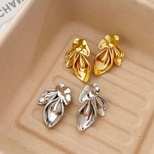 Detailed close-up of Calla Lily flower drop earrings in gold and silver finishes