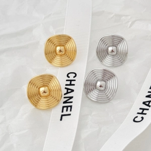 Macro view of vintage textured oval metal stud earrings in gold and silver finish