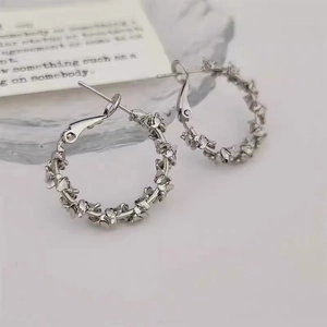 Macro view of silver-colored twisted petal texture on hoop earrings for women