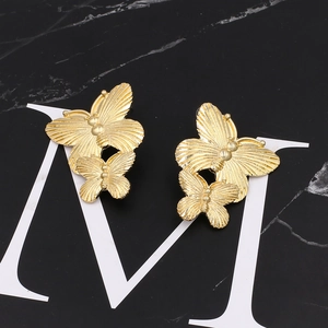 Golden double butterfly earrings with metallic texture and vintage butterfly design