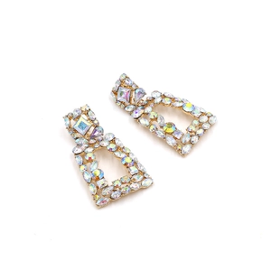 Detail of bohemian geometric gold drop earrings with colorful AB crystals and rhinestones