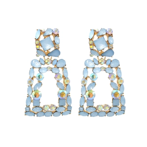Detail of geometric AB rhinestone earrings with blue stones and gold-toned frames
