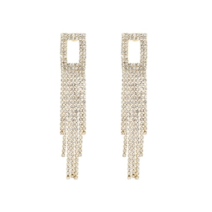 Detail of long gold tassel earrings with shimmering crystals and rectangular stud design