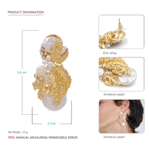 Vintage gold metal leaf earrings with baroque imitation pearls and rhinestone details
