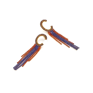 Close-up of bohemian C-shaped earrings with colorful rhinestone fringe tassels