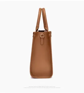 Side view of caramel brown faux leather tote bag with elegant stone texture and gold metal D-ring