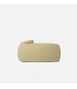 Detail view showing bottom stitching and texture of minimalist light yellow canvas bag