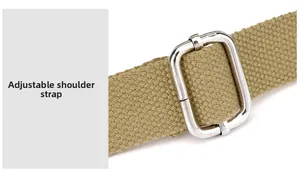 Close-up of adjustable khaki nylon shoulder strap with premium silver metal buckle