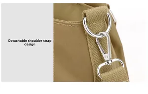 Detail of the detachable shoulder strap with silver lobster clasp on nylon bag