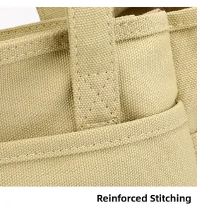 Macro shot of reinforced cross-stitching detail on durable canvas tote bag straps