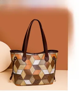 Close-up of geometric patchwork leather tote bag with 3D diamond pattern details