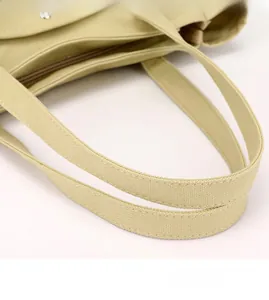Detail of the high-density canvas handbag featuring reinforced stitching and metal hardware