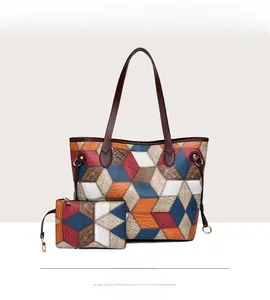 Detail of colorful geometric patchwork tote bag with 3D cube pattern and matching pouch