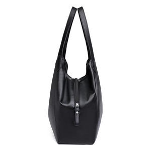 Black textured leather tote bag with vertical zipper detail and long shoulder straps