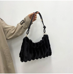 Fashionable black faux fur shoulder bag with vertical pleats and stylish knot detail