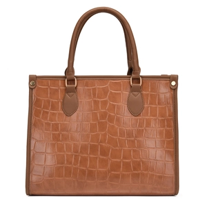 Brown crocodile embossed tote bag with gold hardware and top handles on white background