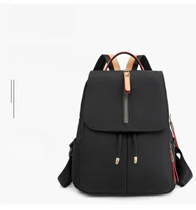 Detail of black waterproof Oxford backpack showing premium gold hardware and zipper texture