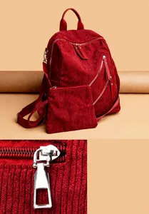Detail of red corduroy backpack featuring high-quality silver metal zipper hardware