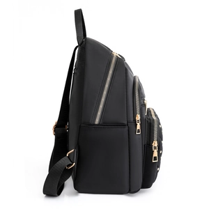Side view of a fashionable black oxford backpack for women with gold zippers and multi-layers