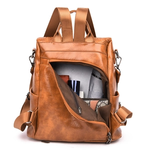 Detail view of the anti-theft back zipper opening and large storage capacity on the brown bag