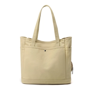 Minimalist beige canvas tote bag with multi-pockets and sturdy handles for commuting