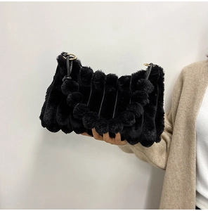 Detailed close-up of a black faux fur shoulder bag with vertical texture and golden hardware