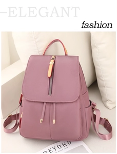 Detail view of pink waterproof nylon backpack with vertical zipper and side pockets