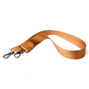 Close-up of adjustable brown nylon shoulder strap with leather trim and metal hook