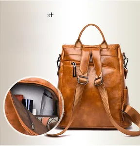 Detail view of anti-theft brown faux leather backpack with rear zipper and spacious interior
