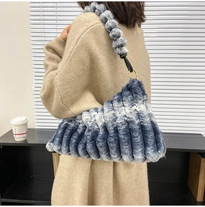 Close-up of blue and white gradient faux fur shoulder bag with soft wave texture